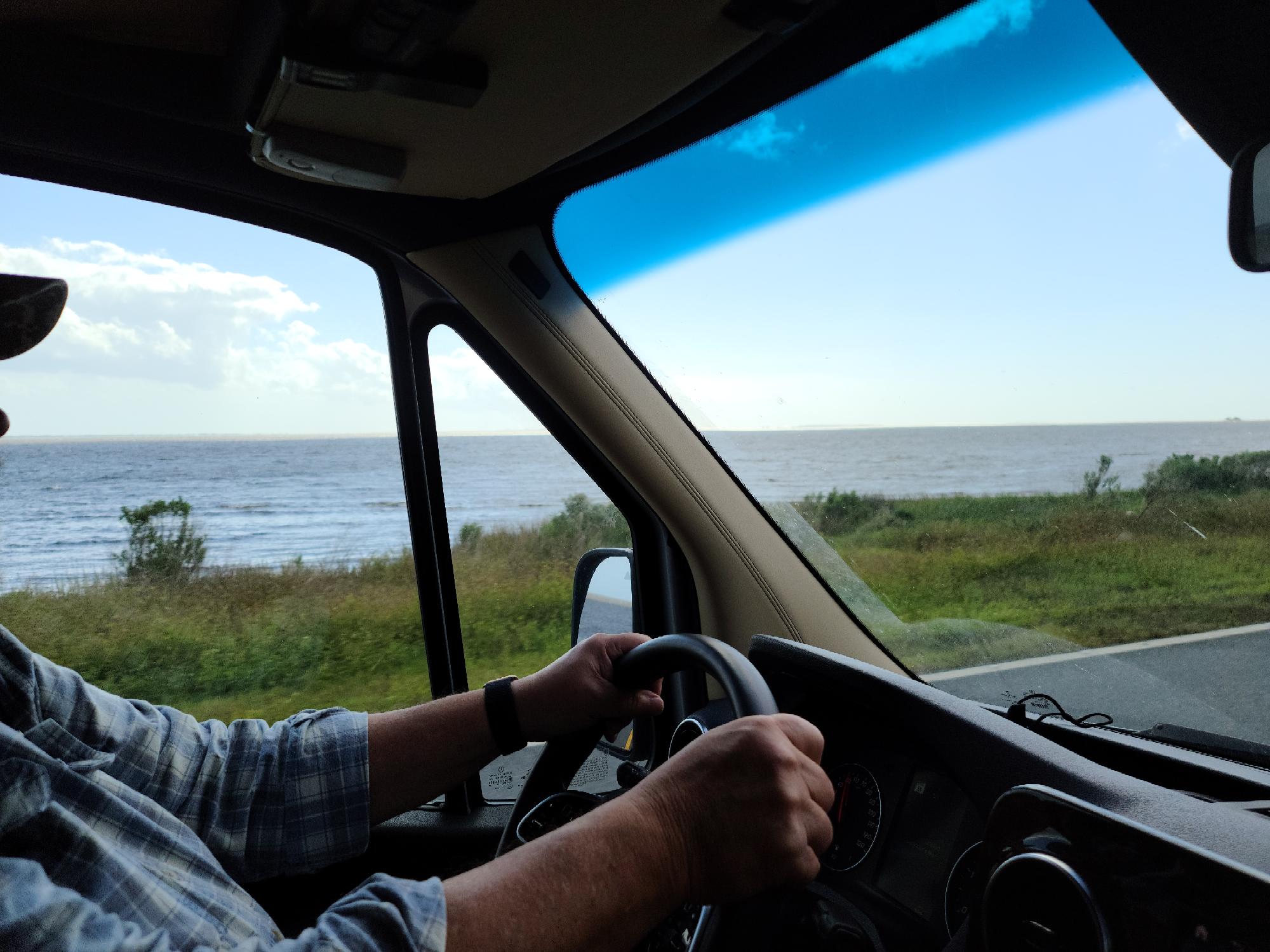 interior shot of a man driving a car