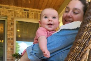 mother and baby in a wicker chair