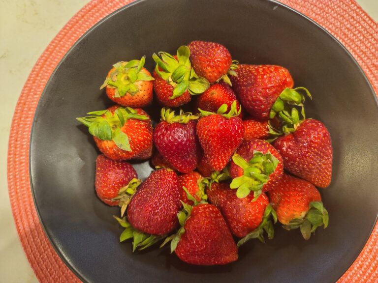a plate full of strawberries